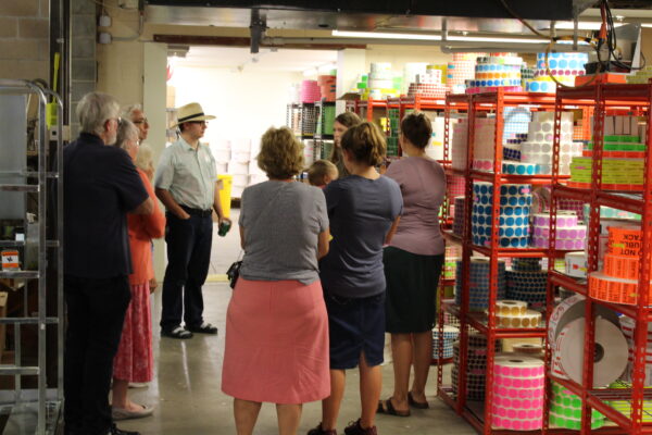 Guests are surrounded by labels that are ready to be finished and shipped