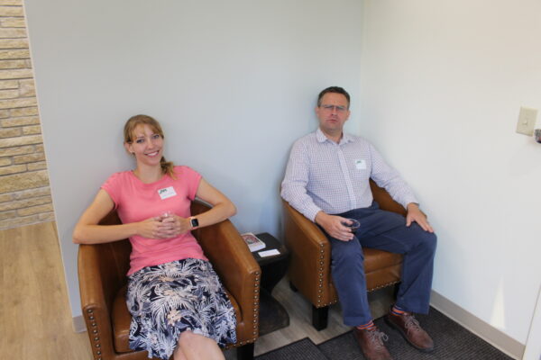 Jackie Goldade and Patrick Werick model the new chairs in the reception area